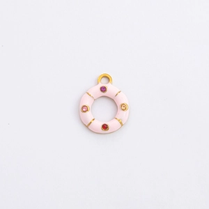 Macro shot of gold-plated lifebuoy charm with pink enamel and colorful small crystals