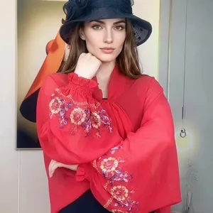 Detail of red chiffon shawl with colorful floral embroidery on lantern sleeves