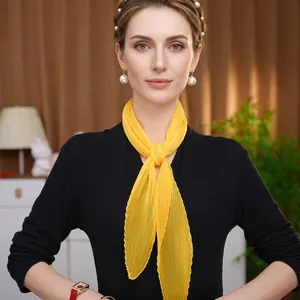 Close-up of yellow pleated chiffon sun protection shawl with fine vertical texture