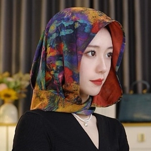 Detail of artistic chiffon scarf with abstract oil painting print worn as a headband