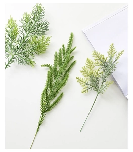 Detailed view of three artificial green cedar branches for Christmas DIY decorations