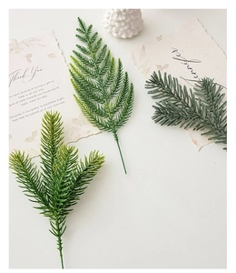 Detailed view of three realistic artificial pine branches with natural green gradients
