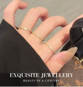 Close-up of three slender 18k gold plated titanium rings with pavé cubic zirconia