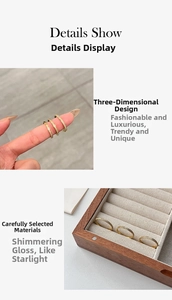 Detailed macro view of three minimalist 18k gold plated titanium rings with pavé zircon