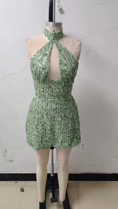 Detail of light green sequined halter dress featuring hollow teardrop cutout and glittery texture
