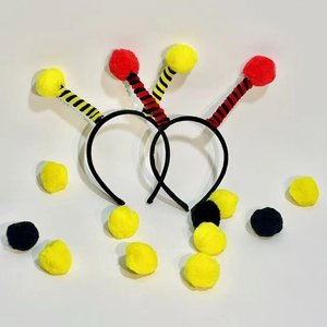 Detail view of insect antenna headbands with fuzzy pom-poms and spiral spring design