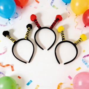 Close-up of three insect antenna headbands with colorful pompoms for festive party costumes
