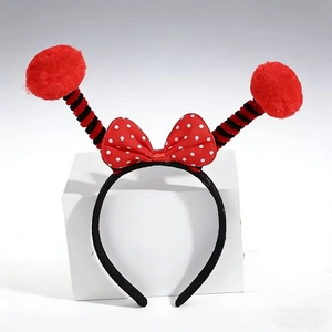 Festive insect headband with red polka dot bow and striped spring antennae pom poms