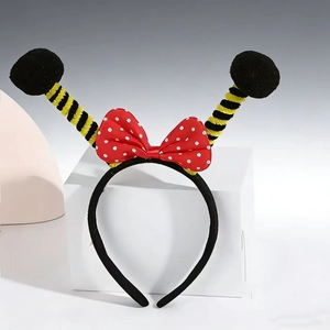 Detail of bee headband with yellow striped feelers and red polka dot bow decoration