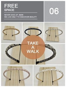 Close-up of handmade crystal beaded headbands in six stylish colors on wooden stands