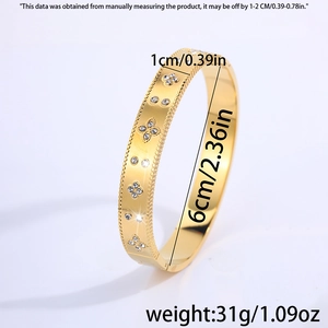 Detail view of 1cm gold titanium steel clover bangle with perlee edges and crystals