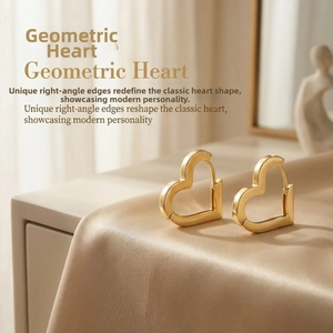 Macro shot of 18K gold hollow heart earrings on champagne satin with glossy finish