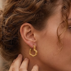 Minimalist hollow heart hoop earrings in gold finish for a modern and stylish look