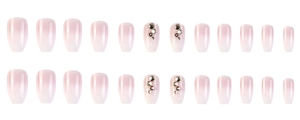 Macro view of short square press-on nails with pink gradient and rhinestone accents