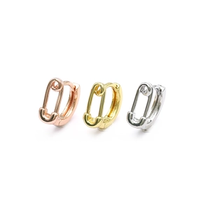 Three safety pin hoop earrings in gold, rose gold, and silver tones with zircon heart