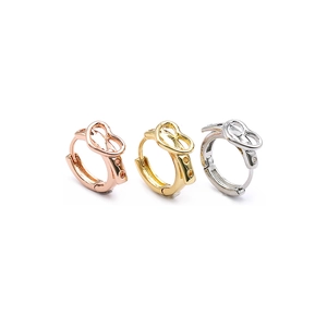 Detailed view of heart-shaped hoop earrings in rose gold, yellow gold, and silver finishes