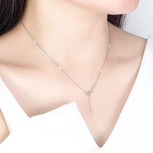 Close-up of S925 sterling silver Y-shaped necklace featuring a bead and needle pendant