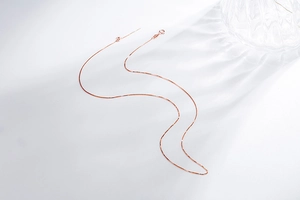 Detail of rose gold S925 sterling silver box chain with lobster clasp on white background