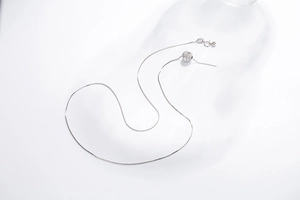Detail of adjustable S925 sterling silver box chain with sparkling pavé crystal ball pendant