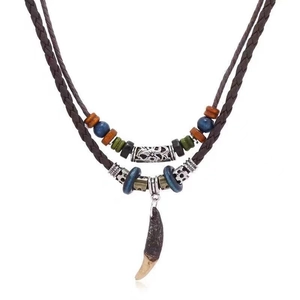Ethnic double-layer necklace with wooden beads and tribal tusk pendant on white background