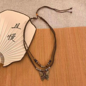 Ethnic double-layer necklace with wooden beads and vintage bronze butterfly pendant