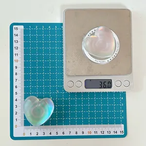 Macro detail of iridescent heart phone grip showing 4.5cm size and 36g weight on scales