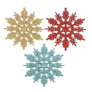 Three-piece set of glittery Christmas snowflake ornaments in gold, red and blue colors