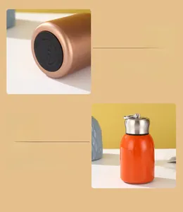 Macro detail of orange mini vacuum flask base and stainless steel lid with ring