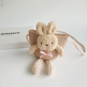 Détail d'un sac en paille pour enfants avec lapin en peluche et fermeture éclair argent