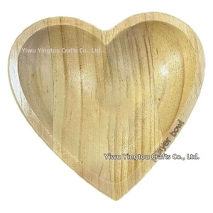 Detail view of heart-shaped wooden prayer bowl featuring natural grain and engraved text
