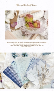 Detailed close-up of mixed texture decorative lace and grid pattern scrapbook paper sheets
