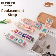 Detail of adjustable boho embroidered purse straps with light gold hardware clasps