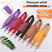 Detail showing adjustable embroidered jacquard bag straps with widened pressure relief pads