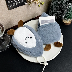 Cute plush animal coin purse with zipper in a decorative setting for small essentials