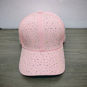 Detailed close-up of pink baseball cap featuring colorful all-over rhinestone embellishments