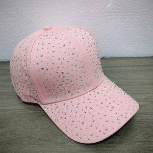 Close-up of pink baseball cap with sparkling AB rhinestones and a curved brim