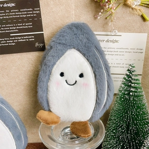 Close-up of cute plush penguin coin purse with soft grey fur and rosy cheeks detail