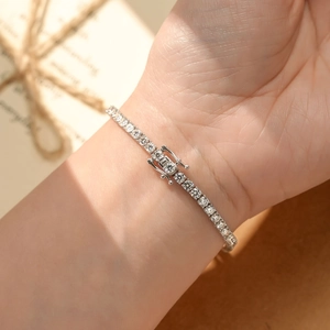 Detailed close-up of a s925 silver moissanite tennis bracelet with secure clasp on wrist