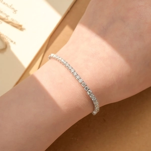 Close-up of a sparkling moissanite tennis bracelet in S925 sterling silver on a wrist