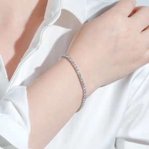 Close-up of S925 sterling silver moissanite tennis bracelet on model's wrist