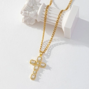 Macro shot of gold-plated cross pendant with sparkling zircons on a classic chain