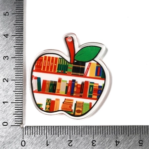 Apple-shaped acrylic book charm with colorful library print measuring 3.5cm for DIY jewelry