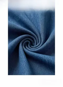 Macro shot of dark blue denim fabric showing detailed twill weave and soft texture