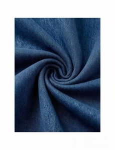 Macro shot of blue denim fabric showing twill weave and light washed texture detail