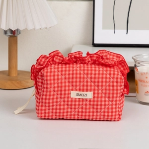 Detail of red gingham quilted cosmetic bag with ruffled lace trim and JIMEIZI label