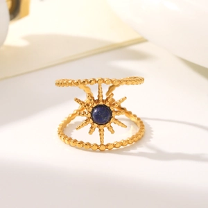 Detailed macro of gold sunburst ring with blue lapis stone and beaded double band