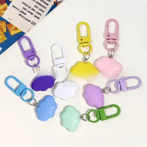 Macro detail of eight colorful resin cloud keychains with matching metal lobster clasps