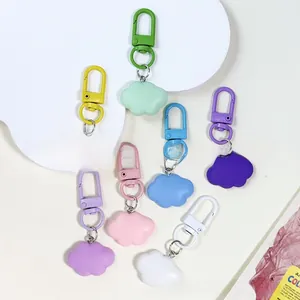 Close-up of seven colorful resin cloud charms with matching matte lobster clasps