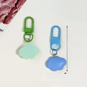 Macro detail of cute resin cloud pendants with matching metal lobster clasps in soft colors