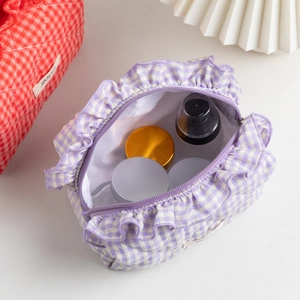 Macro shot of large capacity purple plaid ruffle makeup bag showing interior storage space
